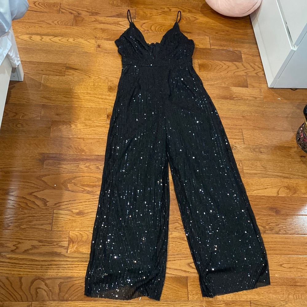 Black sequence, shiny medium sized jumpsuit. NEVER WORN.